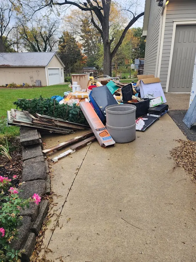 Dumpster being loaded with debris for 12 Yard Dumpster Rental in Smithfield